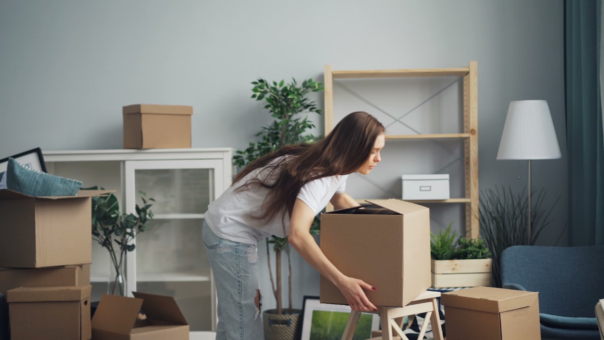 Woman packing moving boxes in an apartment